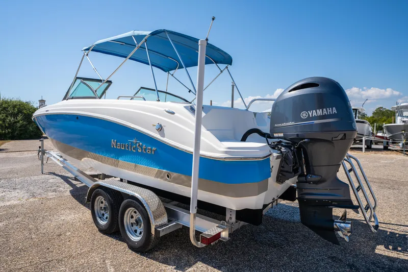 Slide: The Image of 2017 NauticStar 223DC Sport Deck boat with Yamaha engine on trailer, blue and white design. - 4
