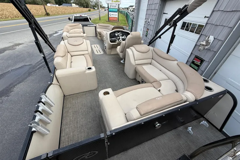 Slide: The Image of 2018 Avalon 2585 Catalina Elite Tri-toon boat with beige seating and spacious deck layout. - 11