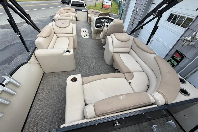 Slide: The Image of 2018 Avalon 2585 Catalina Elite Tri-toon boat interior with beige seating and steering console. - 12