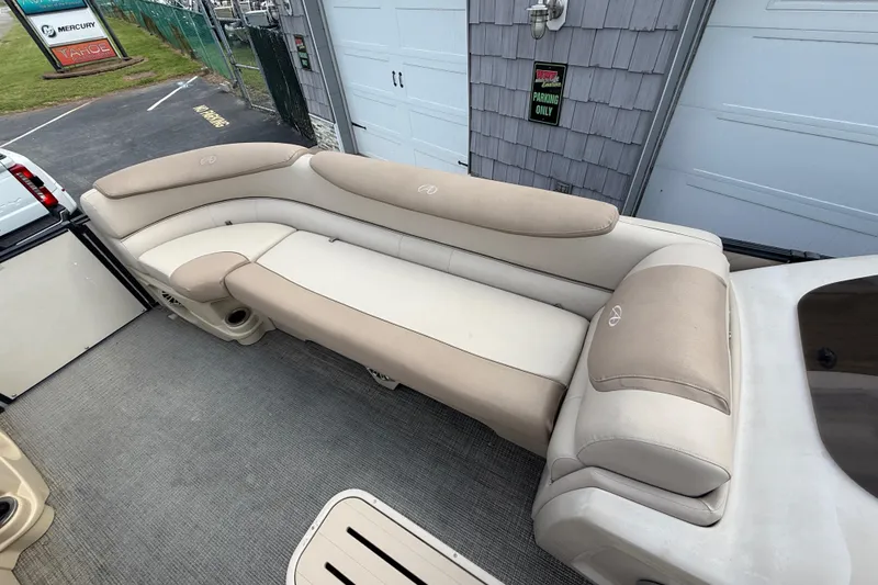 Slide: The Image of 2018 Avalon 2585 Catalina Elite Tri-toon boat with beige seating and carpeted deck. - 13