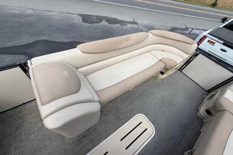 Slide: The Image of 2018 Avalon 2585 Catalina Elite Tri-toon boat interior with beige seating and carpeted flooring. - 14