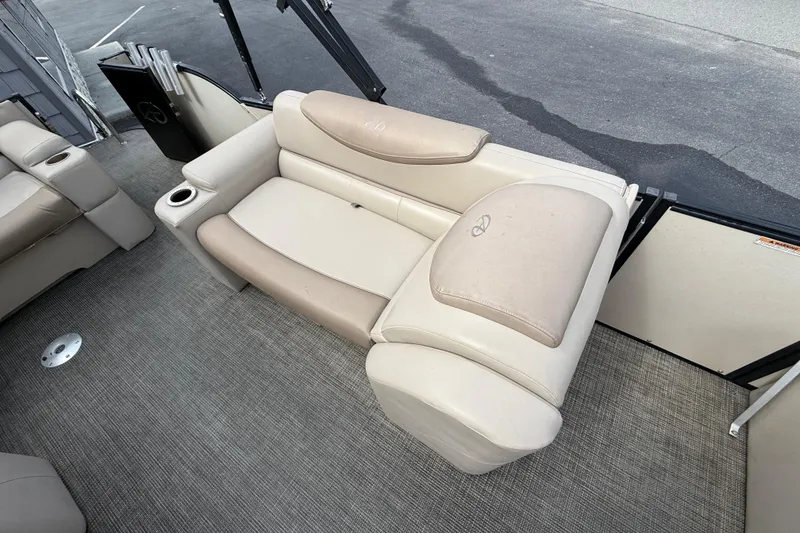 Slide: The Image of 2018 Avalon 2585 Catalina Elite Tri-toon boat interior with beige seating and cup holder. - 17
