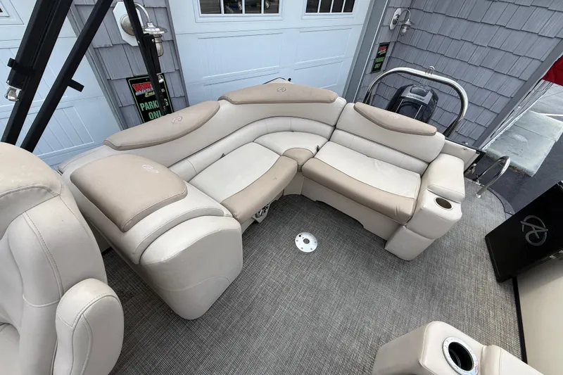 Slide: The Image of 2018 Avalon 2585 Catalina Elite Tri-toon boat with beige seating and carpeted deck. - 18