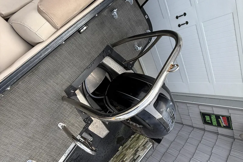 Slide: The Image of 2018 Avalon 2585 Catalina Elite Tri-toon boat engine and seating area. - 25