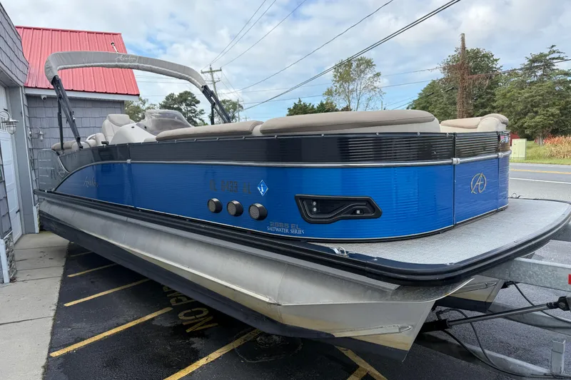 Slide: The Image of 2018 Avalon 2585 Catalina Elite Tri-toon boat with blue exterior, parked on a trailer. - 9