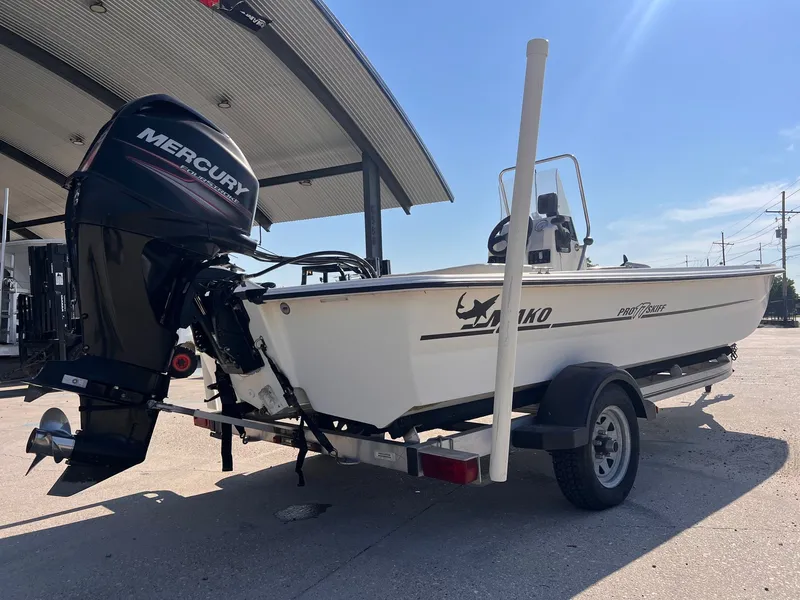 Slide: The Image of 2016 Mako Pro 17 Skiff CC boat with Mercury outboard motor on trailer. - 2