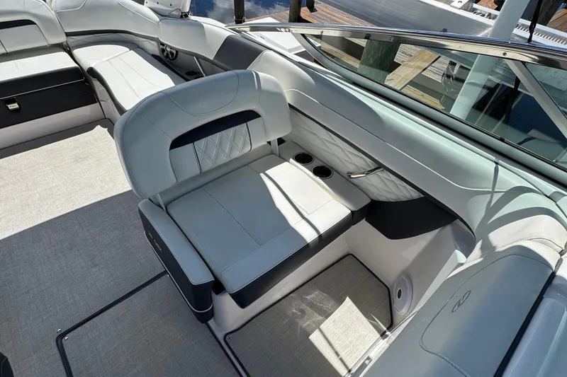 Slide: The Image of 2021 Regal 26 OBX boat interior with luxurious seating and cup holders. - 11