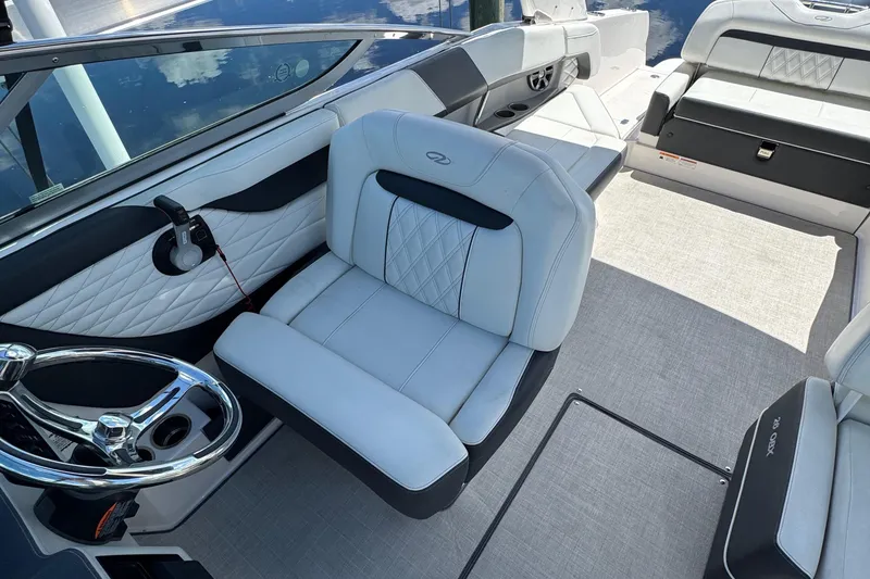 Slide: The Image of 2021 Regal 26 OBX boat interior with luxurious seating and modern steering wheel. - 12