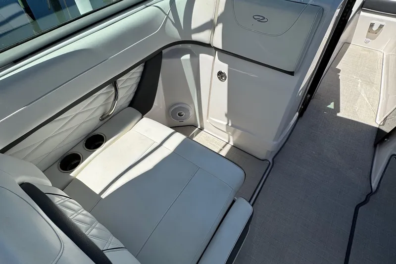 Slide: The Image of Interior of 2021 Regal 26 OBX boat with white seating and cup holders. - 19