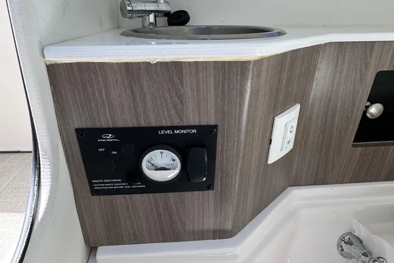 Slide: The Image of 2021 Regal 26 OBX boat interior with level monitor and sink. - 21