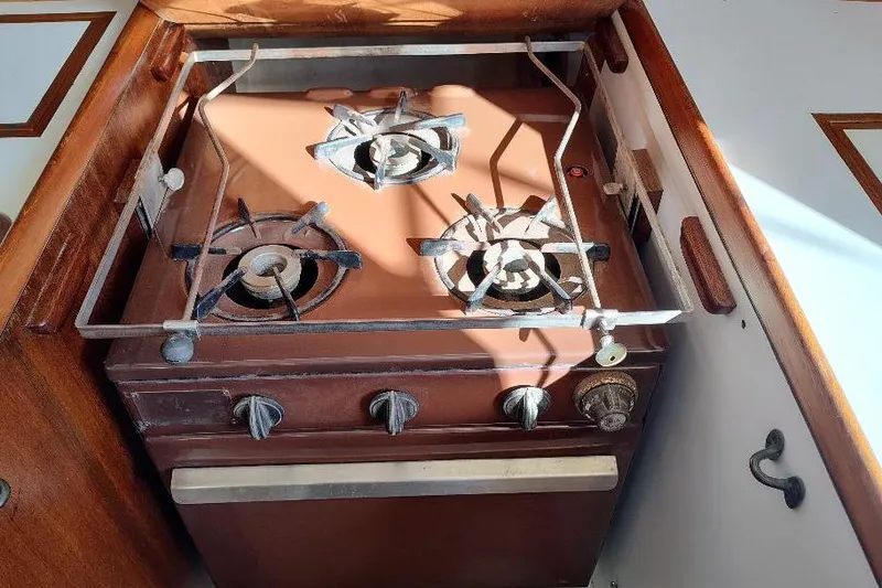 Slide: The Image of Vintage 1979 Bristol Yawl stove with three burners in a wooden kitchen setting. - 21