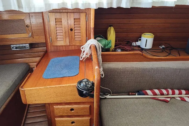 Slide: The Image of 1979 Bristol Yawl interior with wooden cabinetry and nautical equipment. - 25