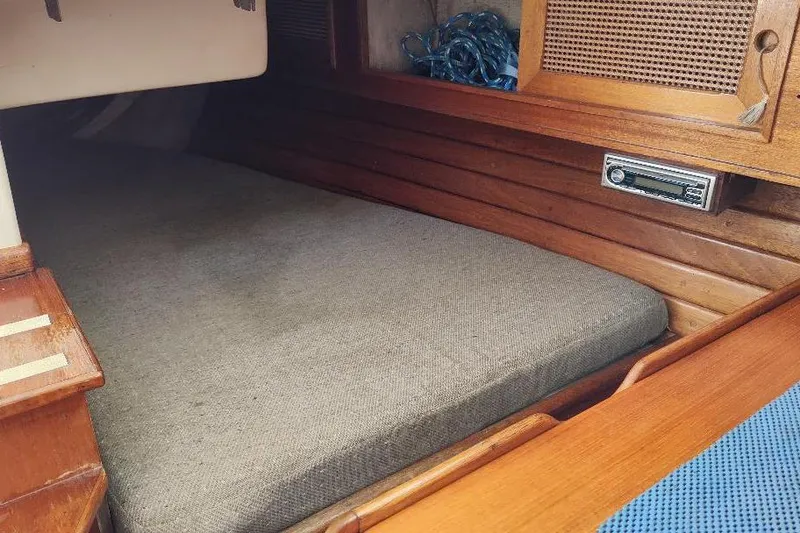 Slide: The Image of Cozy cabin interior of a 1979 Bristol Yawl sailboat with wooden accents. - 26