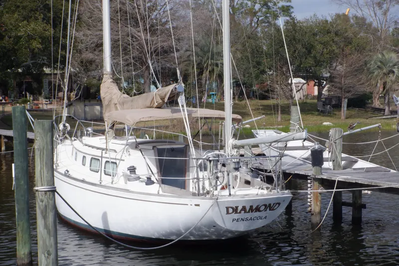 Slide: The Image of 1979 Bristol Yawl sailboat docked, named "Diamond," in a serene marina setting. - 3