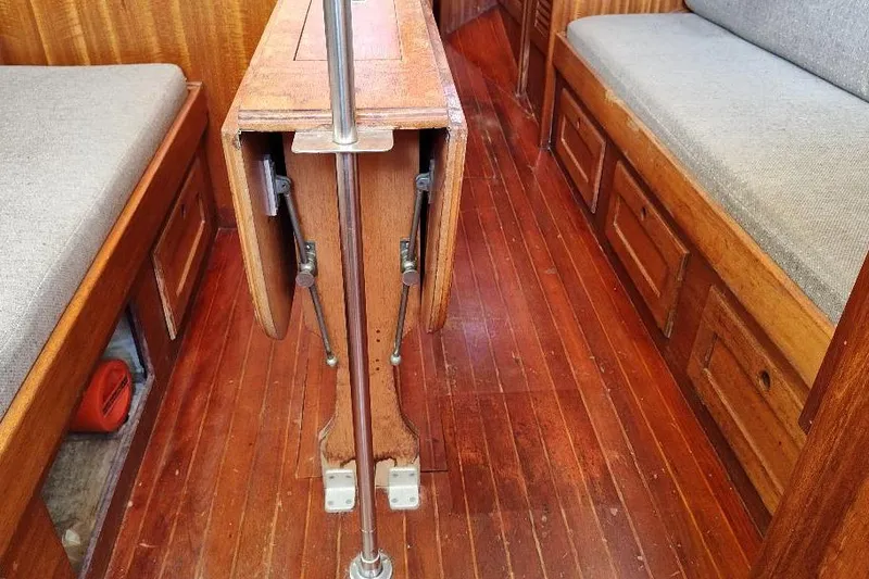 Slide: The Image of 1979 Bristol Yawl interior with wooden flooring and foldable table. - 30