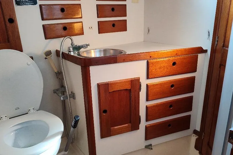 Slide: The Image of 1979 Bristol Yawl bathroom with wooden cabinets and a compact sink. - 34