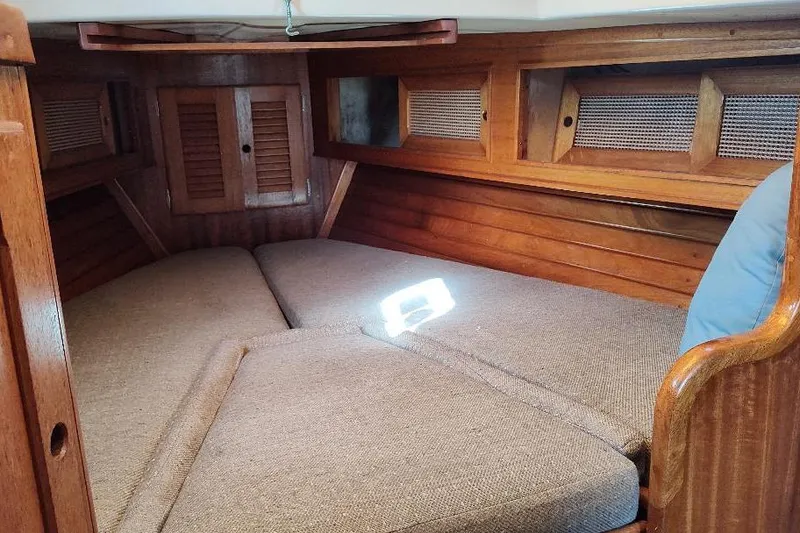 Slide: The Image of Cozy cabin interior of a 1979 Bristol Yawl sailboat with wooden finish. - 35