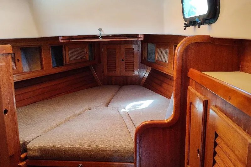 Slide: The Image of Cozy interior cabin of a 1979 Bristol Yawl sailboat with wooden furnishings. - 38