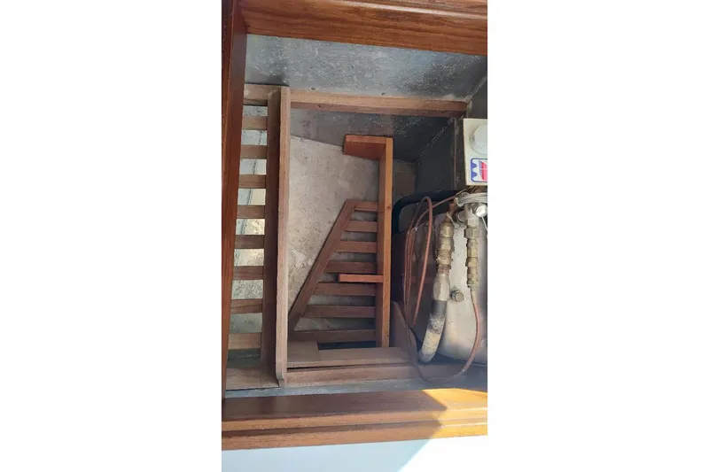 Slide: The Image of Wooden steps and engine compartment of a 1979 Bristol Yawl sailboat. - 39