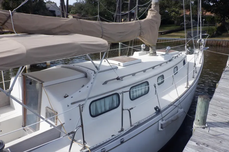 Slide: The Image of 1979 Bristol Yawl sailboat docked, featuring classic design and covered sails. - 9