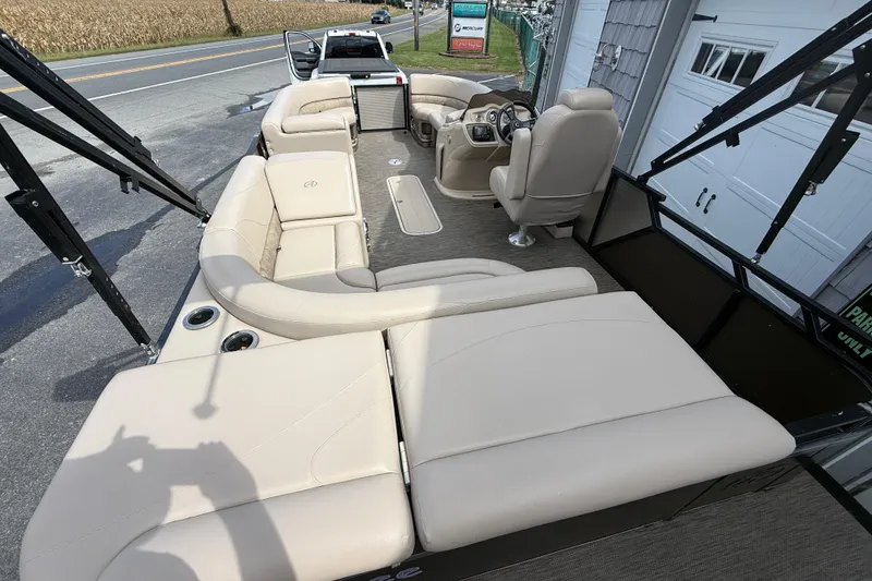 Slide: The Image of 2019 Avalon 2285 LSZ Cruise Tri-toon boat with beige seating and steering console. - 13