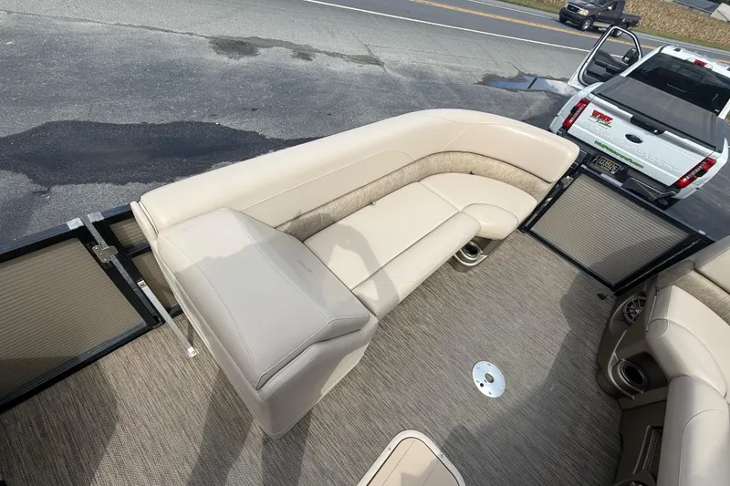 Slide: The Image of 2019 Avalon 2285 LSZ Cruise boat interior with beige seating and carpeted floor. - 15