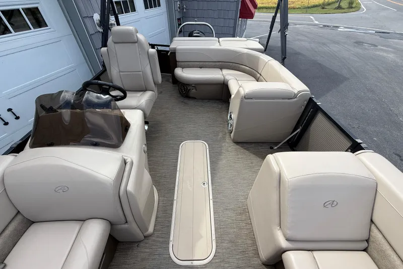 Slide: The Image of 2019 Avalon 2285 LSZ Cruise Tri-toon boat interior with beige seating and steering console. - 17