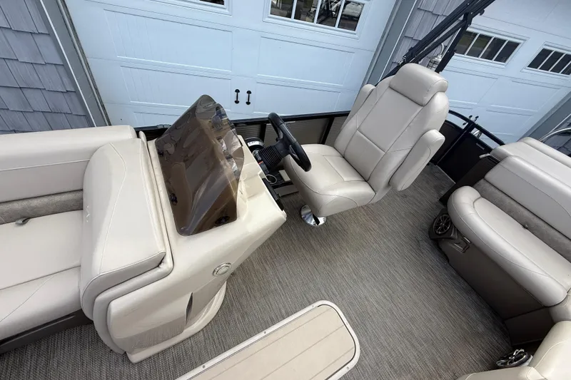 Slide: The Image of 2019 Avalon 2285 LSZ Cruise boat interior with beige seating and steering console. - 18