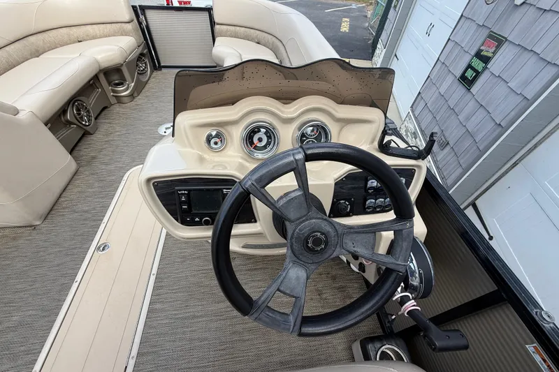 Slide: The Image of 2019 Avalon 2285 LSZ Cruise boat dashboard with steering wheel and controls. - 22