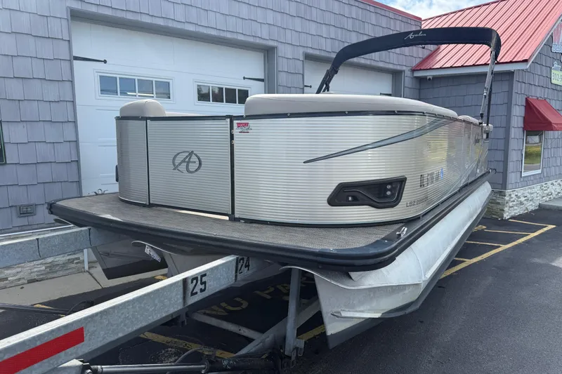 Slide: The Image of 2019 Avalon 2285 LSZ Cruise Tri-toon boat on trailer, parked outside a building. - 3
