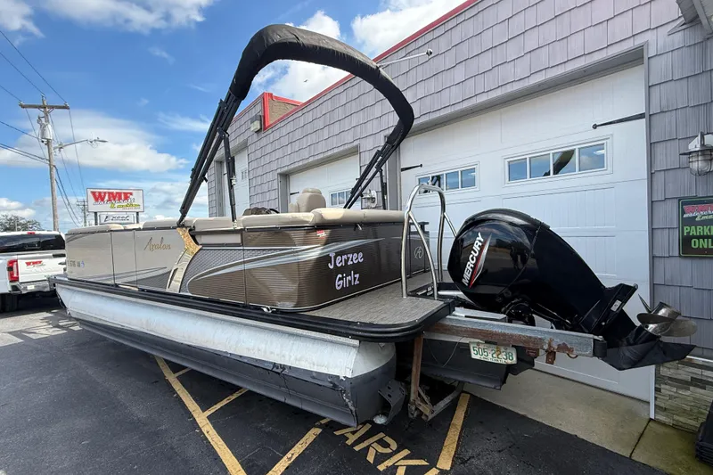 Slide: The Image of 2019 Avalon 2285 LSZ Cruise Tri-toon boat with Mercury engine parked outside. - 5