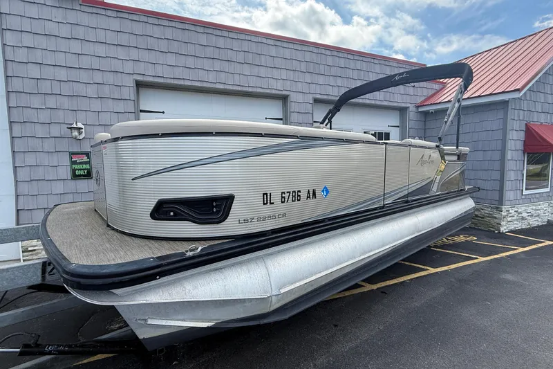 Slide: The Image of 2019 Avalon 2285 LSZ Cruise Tri-toon boat parked outside a building. - 7