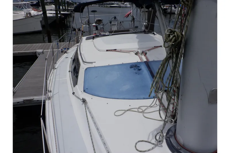 Slide: The Image of 1989 Hunter Vision 32 sailboat docked, showing deck and rigging details. - 18