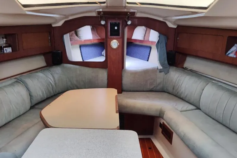 Slide: The Image of Interior of 1989 Hunter Vision 32 sailboat with cozy seating and wooden accents. - 23