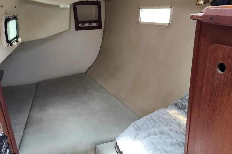 Slide: The Image of Interior cabin of 1989 Hunter Vision 32 sailboat, featuring a cozy sleeping area. - 25