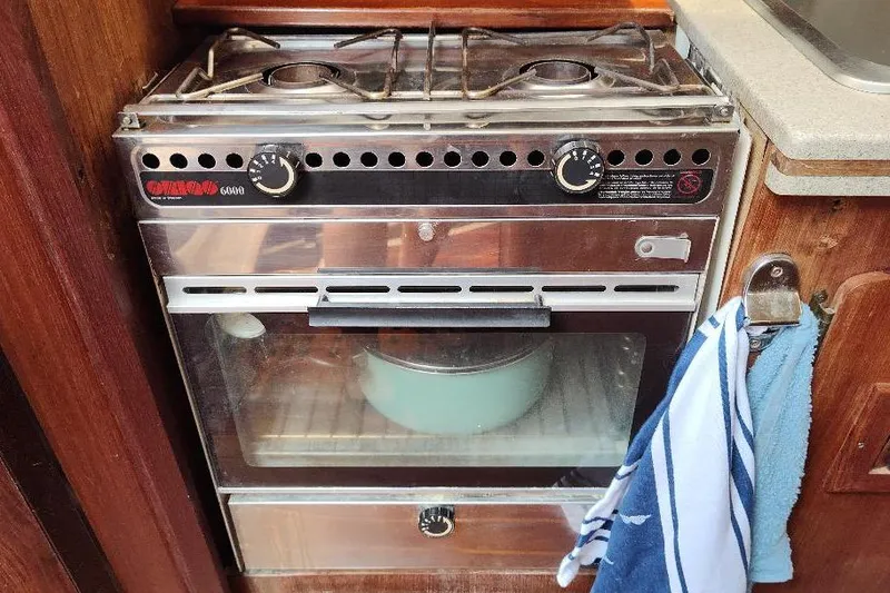 Slide: The Image of Vintage marine stove and oven in a 1989 Hunter Vision 32 yacht kitchen. - 26