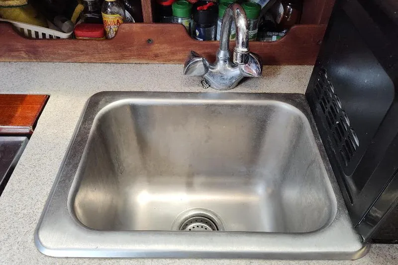 Slide: The Image of Stainless steel sink in a 1989 Hunter Vision 32 yacht kitchen. - 27