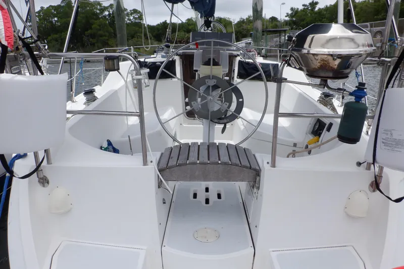 Slide: The Image of Cockpit of 1989 Hunter Vision 32 sailboat with steering wheel and outdoor grill. - 3