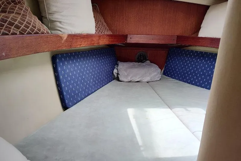 Slide: The Image of Cozy cabin interior of 1989 Hunter Vision 32 sailboat with cushions and pillows. - 31