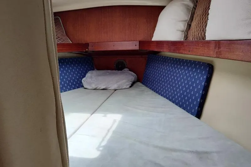 Slide: The Image of Cozy cabin interior of 1989 Hunter Vision 32 sailboat with cushions and pillows. - 32