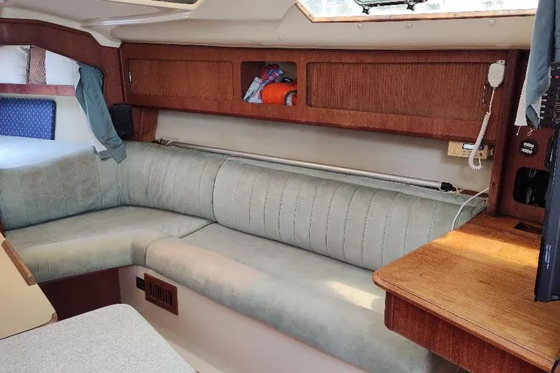 Slide: The Image of Interior of 1989 Hunter Vision 32 sailboat with cozy seating and wooden cabinetry. - 33