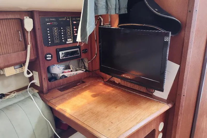 Slide: The Image of 1989 Hunter Vision 32 yacht interior with control panel and mounted TV. - 34