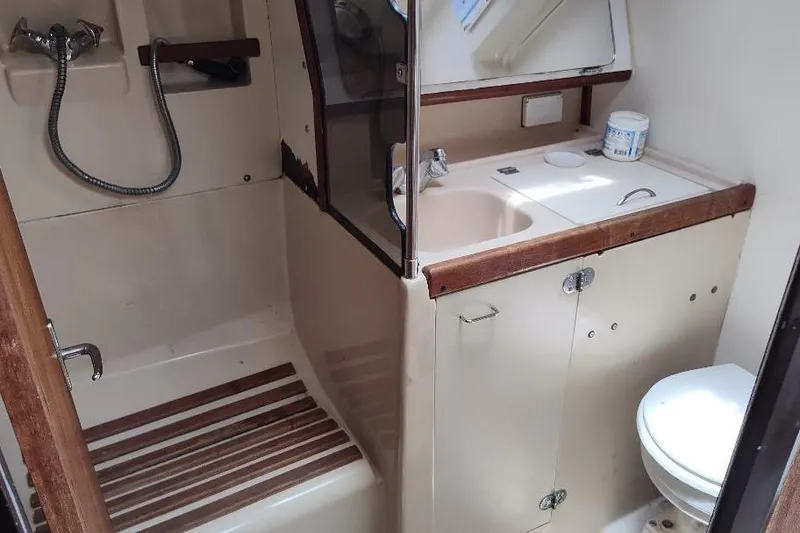 Slide: The Image of 1989 Hunter Vision 32 yacht bathroom with shower, sink, and toilet. - 39