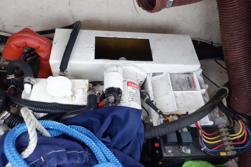 Slide: The Image of Engine compartment of a 1989 Hunter Vision 32 sailboat with various components and wiring. - 7