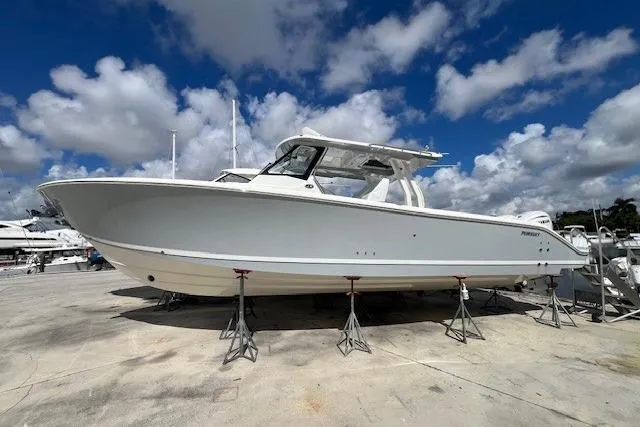 The Image of 2026 Pursuit S 358 Sport boat on stands under a blue sky. - 0