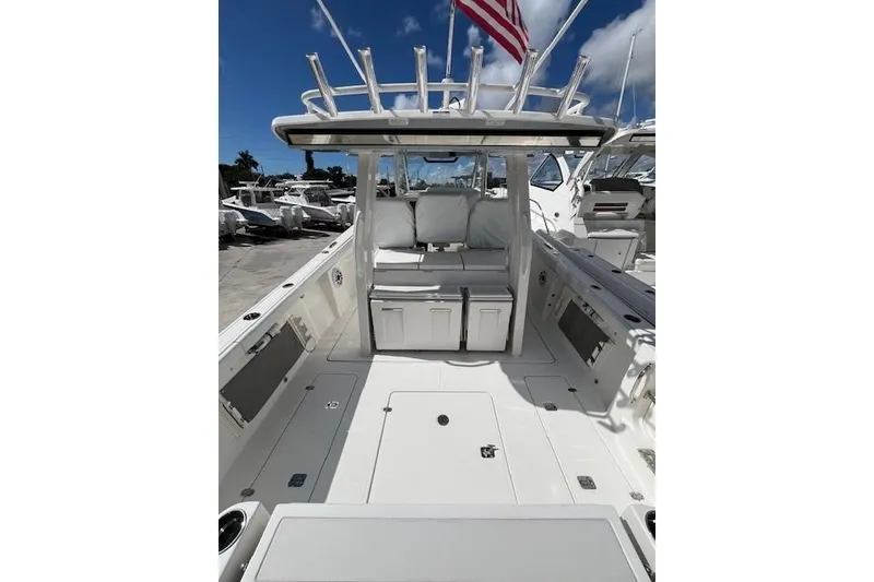 Slide: The Image of 2026 Pursuit S 358 Sport boat interior with seating and storage, under a clear blue sky. - 3