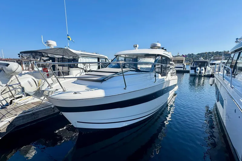 Slide: The Image of 2020 Jeanneau NC 895 boat docked at marina under clear blue sky. - 10