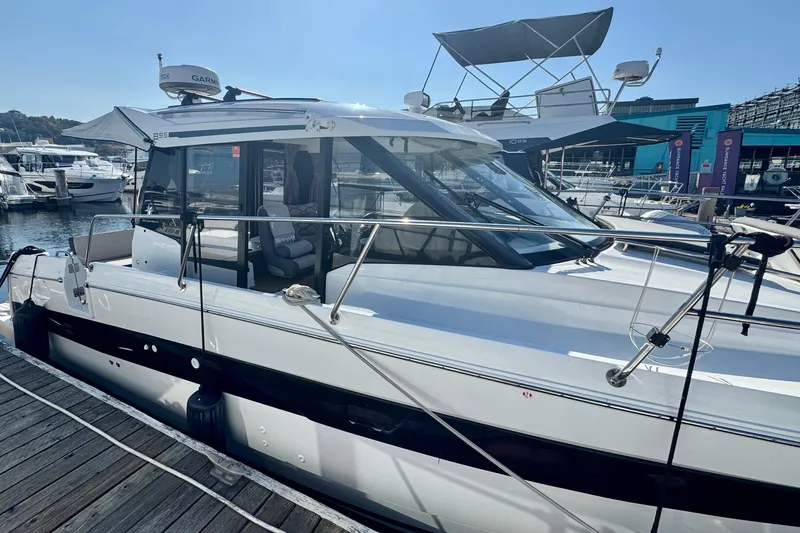 Slide: The Image of 2020 Jeanneau NC 895 boat docked at marina, featuring sleek design and modern amenities. - 12