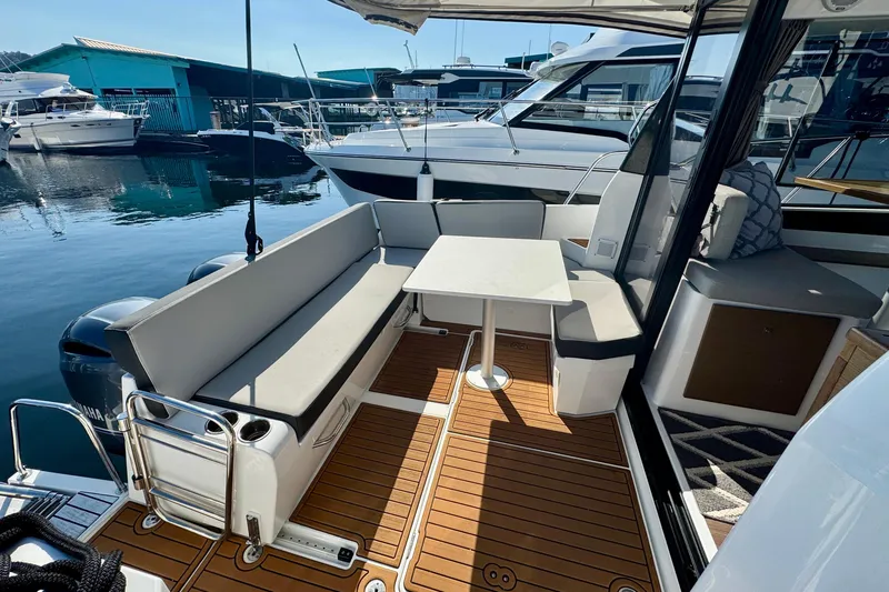 Slide: The Image of 2020 Jeanneau NC 895 boat interior with seating and table, docked at marina. - 14