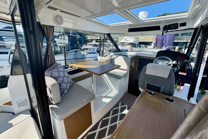 Slide: The Image of Interior of 2020 Jeanneau NC 895 boat with seating, table, and helm station. - 15